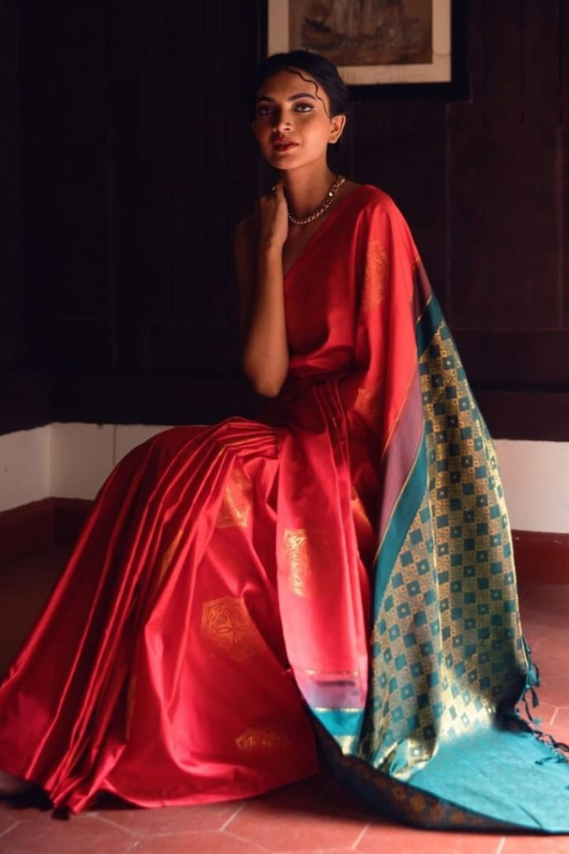 Symmetrical Red Soft Silk Saree With Beguiling Blouse Piece