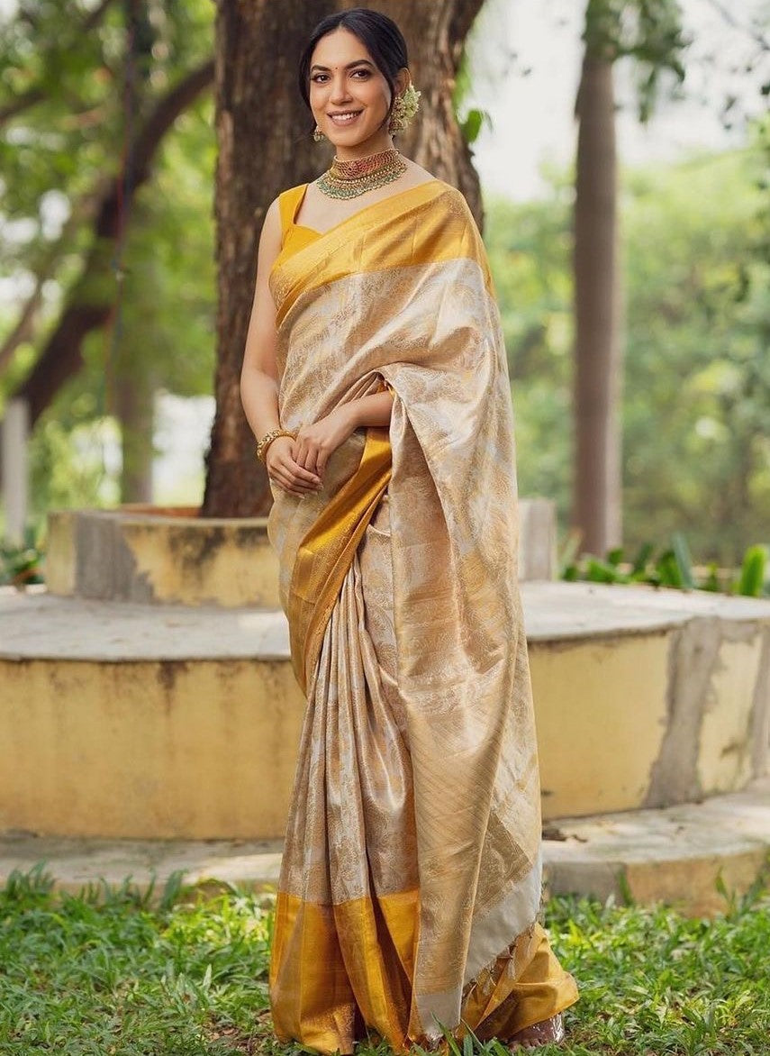 Bewitching Beige Soft Silk Saree With Brood Blouse Piece