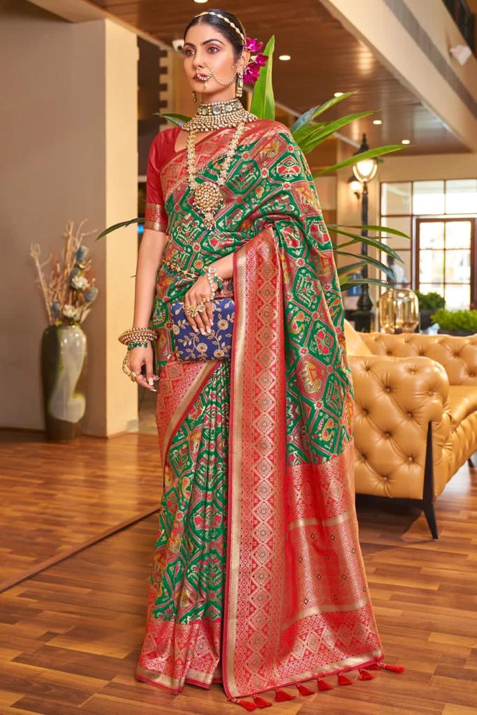 Snazzy Dark Green Patola Silk Saree With Beguiling Blouse Piece