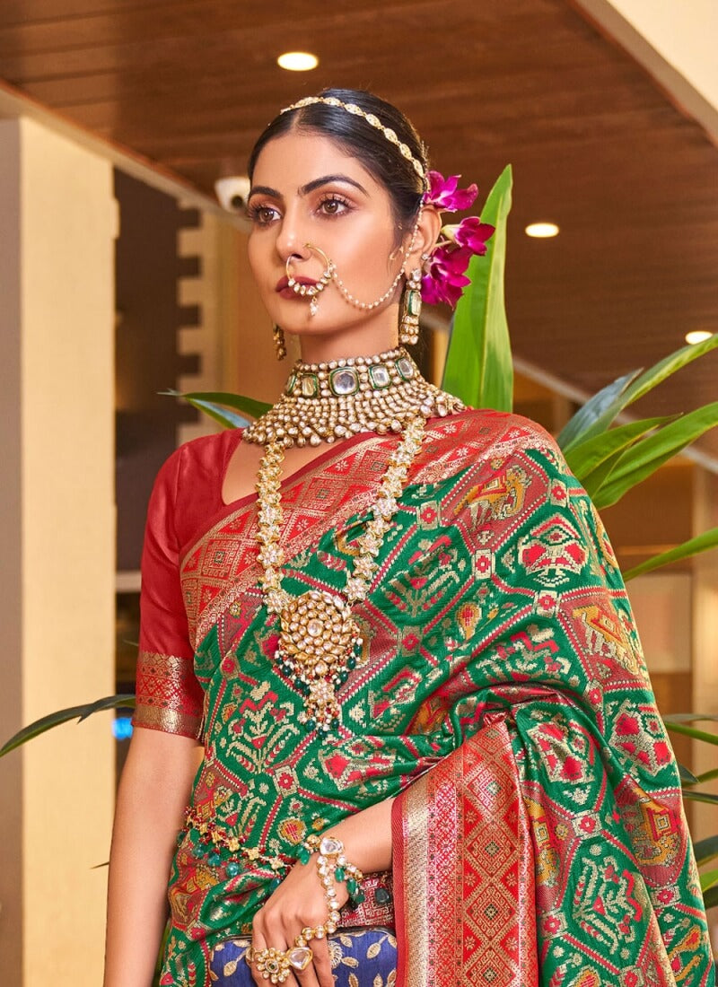 Snazzy Dark Green Patola Silk Saree With Beguiling Blouse Piece