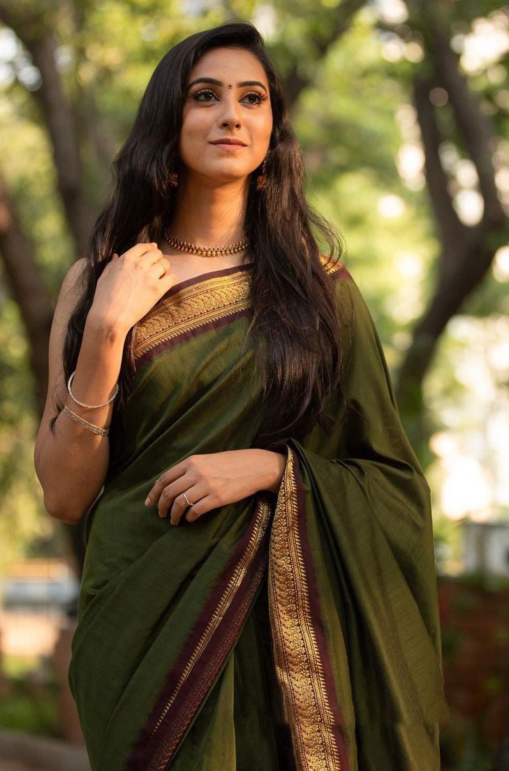 Adorning Green Soft Banarasi Silk Saree With Confounding Blouse Piece